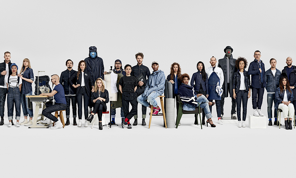 Pharrell Williams, centre, in blue, with G-Star Raw staff